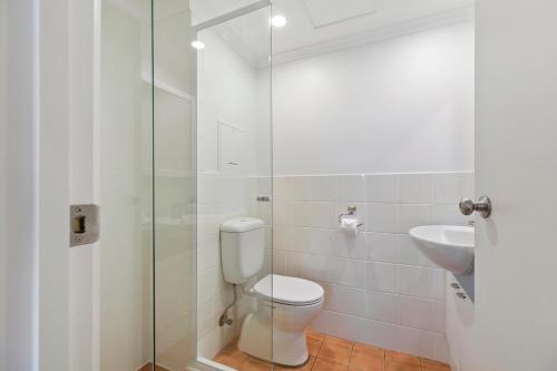 a bathroom with a toilet and a sink at Culgoa Point Beach Resort in Noosa Heads