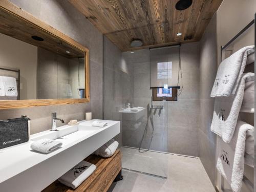 a bathroom with a sink and a shower at Chalet Marcel - Chalets pour 12 Personnes 691 in Saint-Marcel