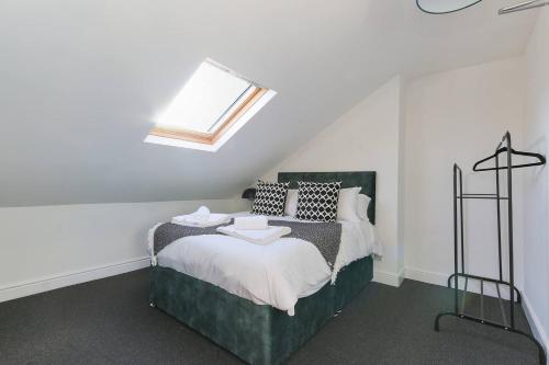 a bedroom with a bed with a skylight at 5 Beds Sleeps 8 Contractor House Permit Park in Nottingham