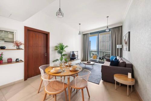 a living room with a table and a couch at FIRST CLASS 1BR Beautifully Furnished in Dubai