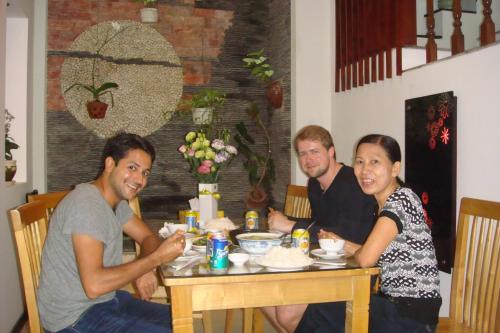 a group of people sitting at a table at Green CoCo HomeStay in Hoi An