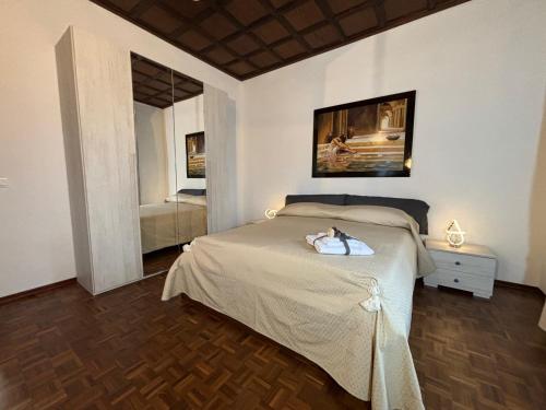 a bedroom with a bed and a mirror at Villanova d'Asti Charming House with barbecue by Alterego in Villanova dʼAsti