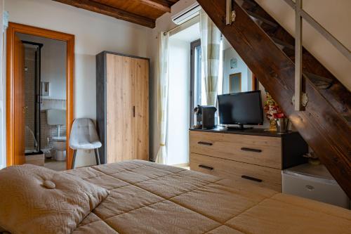 a bedroom with a bed and a tv on a dresser at Le Teste di Moro al Duomo in Agrigento