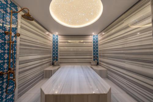 a dressing room with a large chandelier at Mark Warner Phokaia Beach Resort in Foca