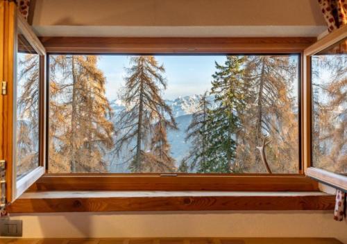 a large window with a view of a mountain view at Baita Stabli-Rifugio Luxury a 1700 mt in Mezzana