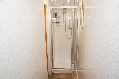 a shower with a glass door in a bathroom at Lily's Place in Cleethorpes