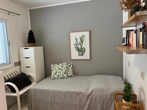 a small bedroom with a bed and a chair at casa yamila in Costa Calma