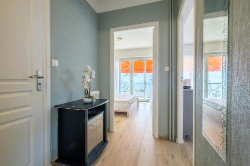 Cette chambre dispose d'un couloir avec une table et une porte. dans l'établissement Angelina - La002, à Cagnes-sur-Mer