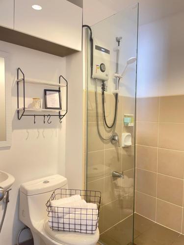 a bathroom with a shower and a toilet at A city escape at the Avida Towers Aspira 1 in Cagayan de Oro