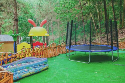 a playground with two trampos and a trampoline at Chou An Hideaway in Hanoi