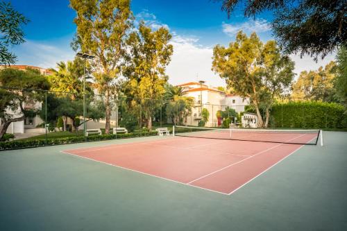 a tennis court in front of a house at Mark Warner Phokaia Beach Resort in Foca