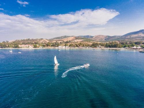 a boat in a large body of water at Mark Warner Phokaia Beach Resort in Foca