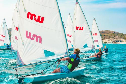 a group of people on sailboats in the water at Mark Warner Phokaia Beach Resort in Foca