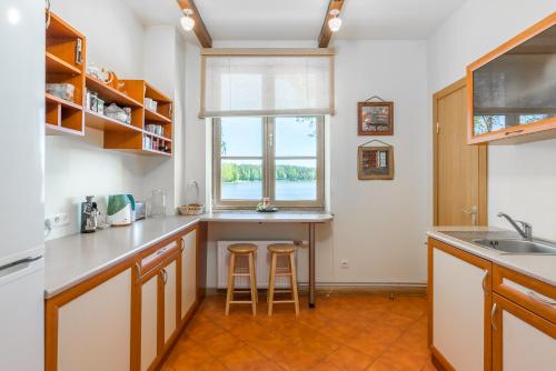 a kitchen with a counter and two stools at Pussala in Daugavpils