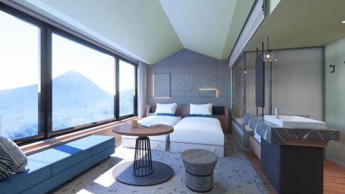 ein Hotelzimmer mit einem Bett, einem Sofa und einem Waschbecken in der Unterkunft Nikko Style Niseko HANAZONO in Kutchan