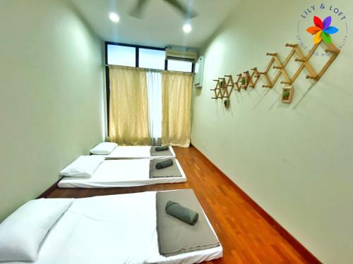 two beds in a room with a window at 40P, Subang Villa with Pool/BBQ/Karaoke/Meeting in Subang Jaya