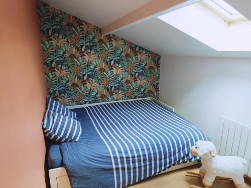 a bedroom with a bed and a stuffed animal at Charmante maison de ville in Lyon