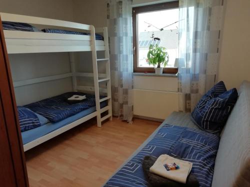 a bedroom with two bunk beds and a window at Ferienwohnung Link in Hellenthal