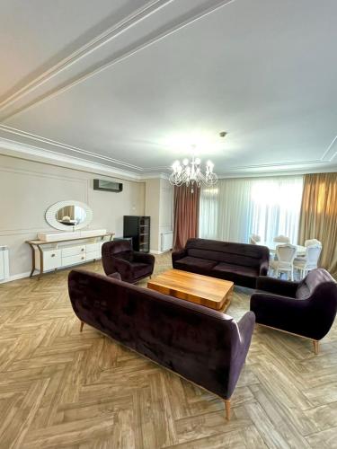 a living room with a couch and a table at Queen Tamar in Batumi
