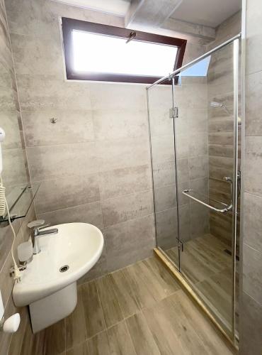 a bathroom with a sink and a shower at Queen Tamar in Batumi