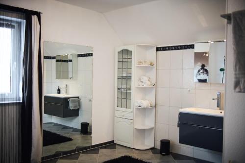 a bathroom with a sink and a mirror at Ferienwohnung im Allgäu in Durach