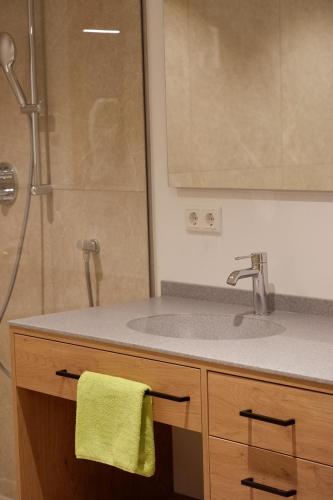 a bathroom with a sink and a shower at Gasthof Schorn in Sankt Leonhard