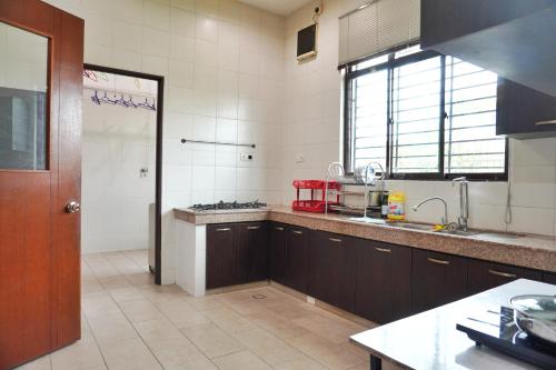 a kitchen with a sink and a counter top at 40P, Subang Villa with Pool/BBQ/Karaoke/Meeting in Subang Jaya