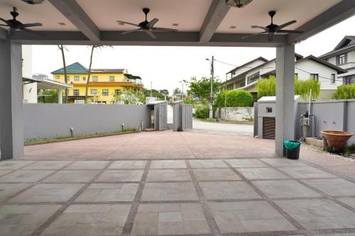 an empty patio with a white fence and ceiling fans at 40P, Subang Villa with Pool/BBQ/Karaoke/Meeting in Subang Jaya