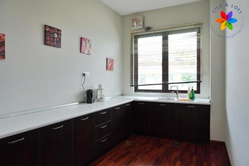 a kitchen with a sink and a window at 40P, Subang Villa with Pool/BBQ/Karaoke/Meeting in Subang Jaya