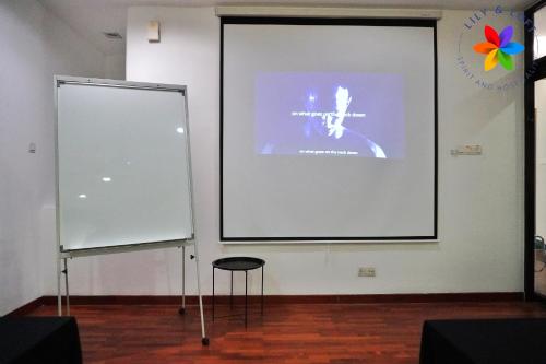 a large white screen with a chair in front of it at 40P, Subang Villa with Pool/BBQ/Karaoke/Meeting in Subang Jaya