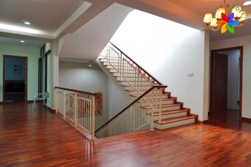 a staircase in a living room with wooden floors at 40P, Subang Villa with Pool/BBQ/Karaoke/Meeting in Subang Jaya