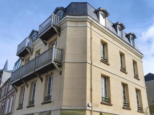 a building with balconies on the side of it at Les Galets Bleus in &Eacute;tretat