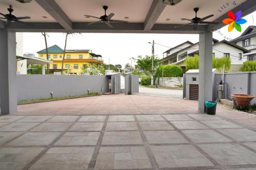 an empty patio with a white fence and ceiling fans at 40P, Subang Villa with Pool/BBQ/Karaoke/Meeting in Subang Jaya
