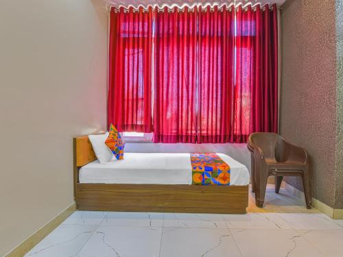 a bedroom with a bed and a window with red curtains at Hotel Harku Villa in Dabok