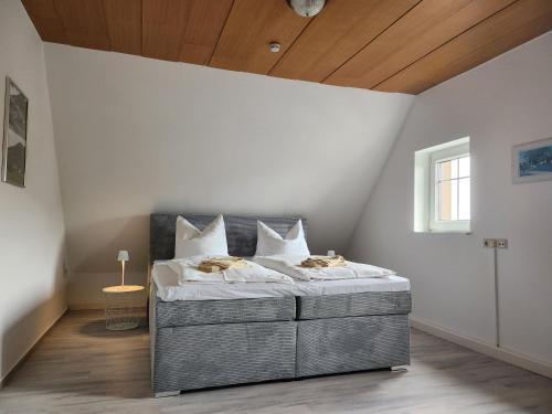 a bedroom with a large bed with a wooden ceiling at Ferienwohnung Auf der Heide in Großschönau