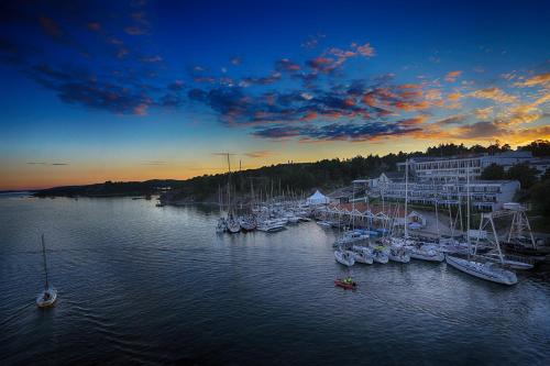 a group of boats are docked in a harbor at Stenungsbaden Yacht Club in Stenungsund
