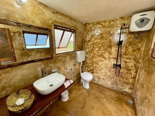 a bathroom with a sink and a toilet at Adventurevilla in Kendwa