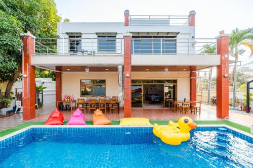 a house with a swimming pool with inflatable toys in it at ไอทะเล พูลล่า หัวหิน I-Talay Poolvilla huahin in Hua Hin