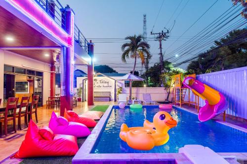 a pool with inflatable rubber ducks in a backyard at ไอทะเล พูลล่า หัวหิน I-Talay Poolvilla huahin in Hua Hin
