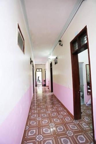 a hallway of a building with a tile floor at Nhà Nghỉ Khánh Linh in Ha Giang