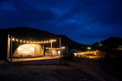 a row of tents in a field at night at Eco Dom Tent in Vedi