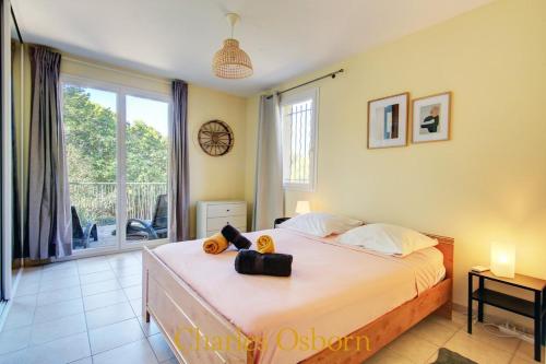 a bedroom with a bed and a large window at Stoneview Villa in Sète