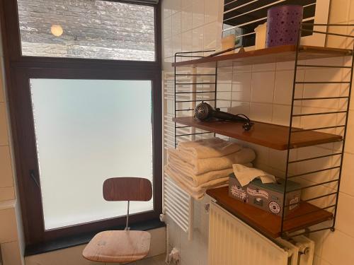 ein Badezimmer mit Fenster und ein paar Handtüchern in der Unterkunft Petite Impasse privée in Brüssel