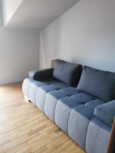 a blue couch sitting in a living room at Arsenal Park Transilvania in Orăştie