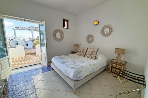 a bedroom with a bed and a view of the ocean at Dependance La Caletta in Panarea