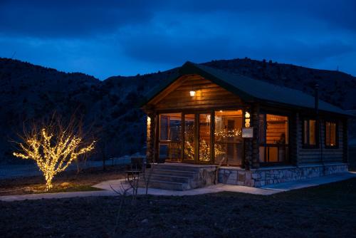 a log cabin at night with mountains in the background at Wooden House in WildLife Refuge in Vedi