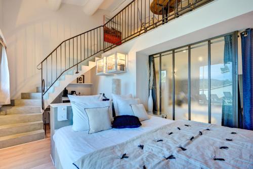 a bedroom with a large bed and a staircase at Hotel Bastide & SPA - Villa de Lourmarin in Lourmarin