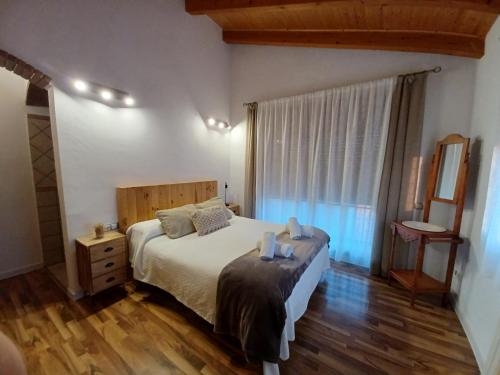 a bedroom with a bed and a large window at Breathtaking views and 2 swimming pools in Lavern