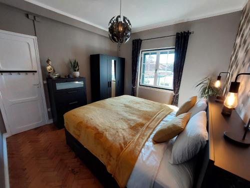 a bedroom with a bed and a desk and a window at Casa Rio Zêzere in Pedrógão Pequeno
