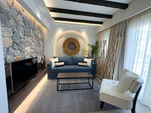 a living room with a blue couch and a fireplace at Urban Gem in the Heart of Naoussa A Stylish Escape in Naousa Imathias